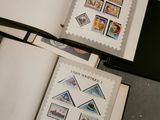 two open books with stamps on them sitting on a table