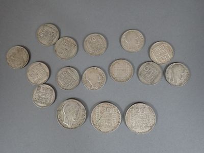several silver coins are arranged in a circle on a gray surface