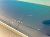 a close up of a car door with a blue paint job on it