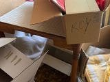 a pile of boxes sitting on the floor next to a table