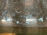 a silver plate with a coat of arms on it