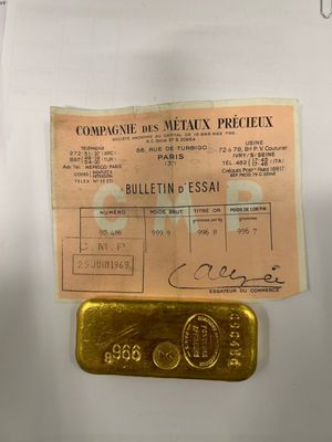 a piece of paper that has a gold bar on it