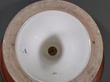 a white and brown vase sitting on a table