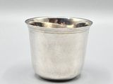 an image of a silver cup sitting on top of a white table