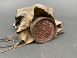 a brown paper bag with a brown speaker on top of it