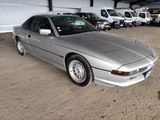 a silver car that is parked in a parking lot