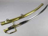 a pair of swords with gold and black handles on a white surface