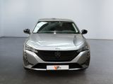 the front view of a silver car parked in a showroom