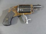 a gun that is on a table with a metal handle