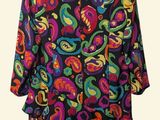 multicolored dress on a hanger on a white background