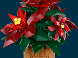 a lego flower pot with red flowers in it