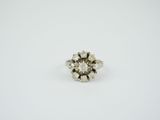 an old cut diamond ring on a white background