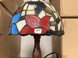 a lamp that is sitting on a table next to boxes