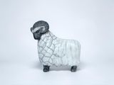 a white and black sheep figurine on a white background