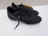 a close up of a pair of black soccer shoes on a table