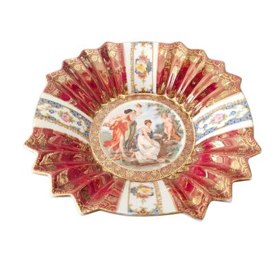 a red and gold plate with a painting on it