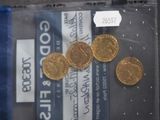 some gold coins in a plastic bag on a table