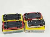 four toy trains sitting in a box on a white surface