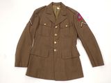 an old military jacket with a patch on the chest and a patch on the shoulder
