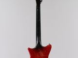 an electric guitar hanging from a string on a white background