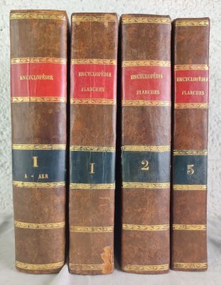 three old books sitting on top of a table next to each other