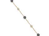 a black and white beaded bracelet with a gold chain