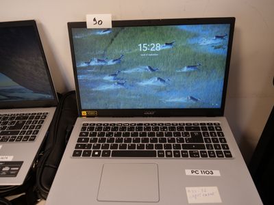 two laptops sitting side by side on a table