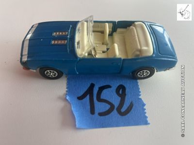 une petite voiture posée sur une feuille de papier bleue