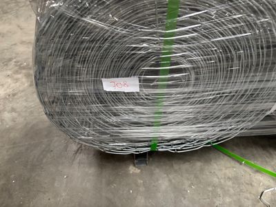 a roll of wire wrapped in plastic on the ground