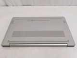a silver laptop computer sitting on a white surface