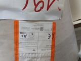 a bag with a sign on it sitting on the ground
