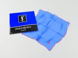 a blue napkin and a blue box of tissues on a white surface