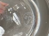 a person cleaning a stainless steel bowl with a rag