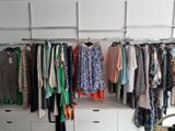 a closet with a lot of clothes hanging on it