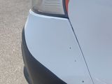 a close up of a white car with a red stripe on it
