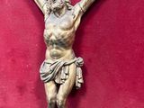 an image of a statue of jesus on a red surface
