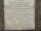 an old document on the ground with a sun in the background