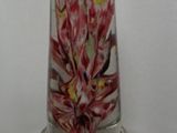 two glass vases with flowers on them on a table