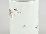 a close up of a white cup with flowers on it