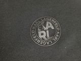 a close up of the back of a black shirt with a logo on it