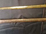 two old baseball bats sitting next to each other on a table
