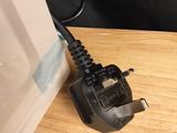 a charger that is plugged into the wall next to a chair