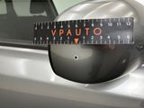 a close up of a car ' s rear view mirror with a measuring tape on it