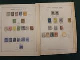an open book with stamps on it sitting on top of a table