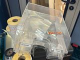 many rolls of tape sitting on a table next to a laptop