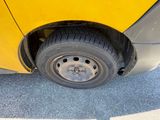a close up of a tire on a yellow car