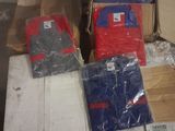 several boxes of clothing are stacked on top of each other in a room