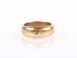 a close up of a gold ring on a white surface