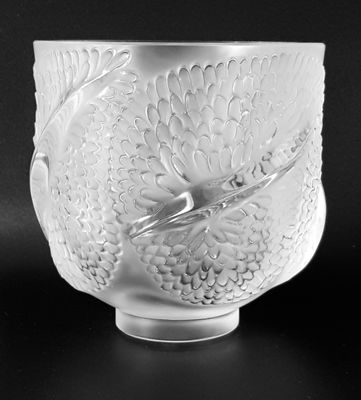 black and white photograph of a glass bowl with a bird on it