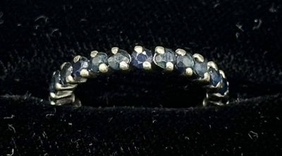 an image of a ring with blue stones on it